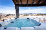 The condo features an oversized patio with private hot tub & mountain views.